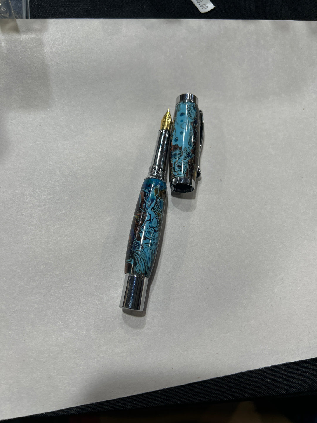 Fine point fountain pen with a silver metal  hardware . And light blue dark blue light brown acrylic . friction finish.