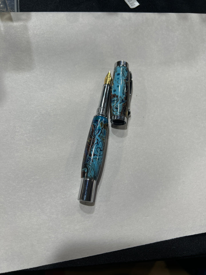 Fine point fountain pen with a silver metal  hardware . And light blue dark blue light brown acrylic . friction finish.