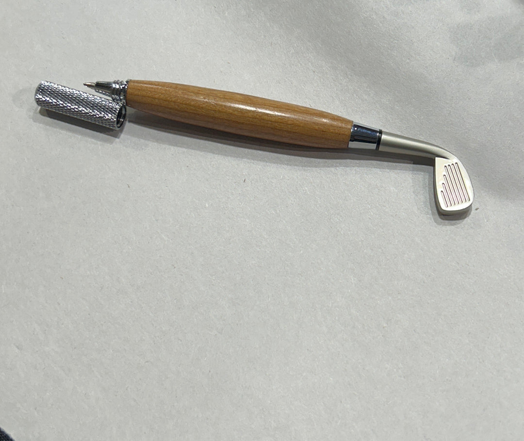 Ball point pen￼with a silver metal hardware and a nickel hardware golfing club. And cherry wood . friction finish.