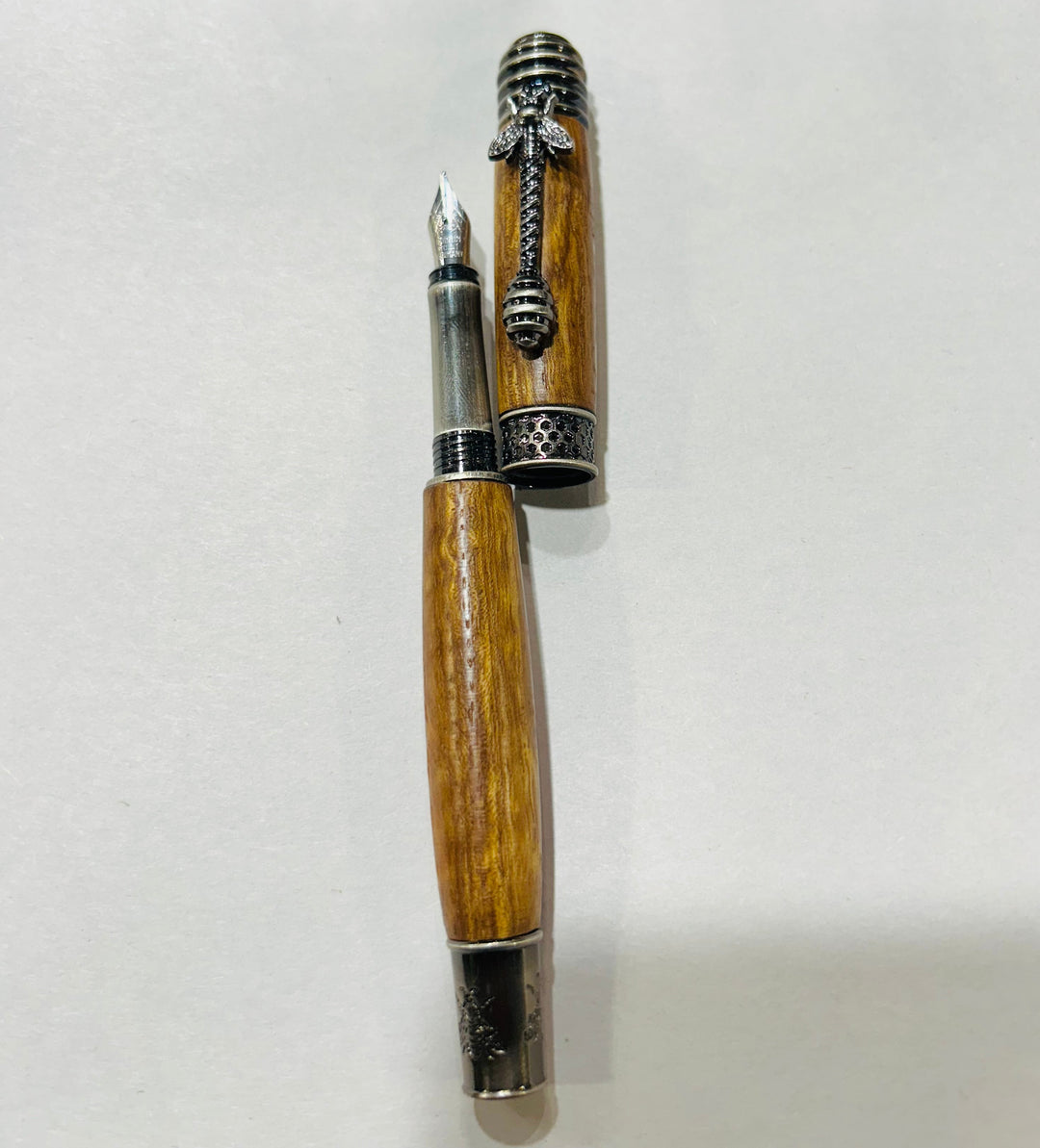 pecan wood hardware  A bee hive medium nib fountain pen with brush nickel metal hardware .And pecan wood.