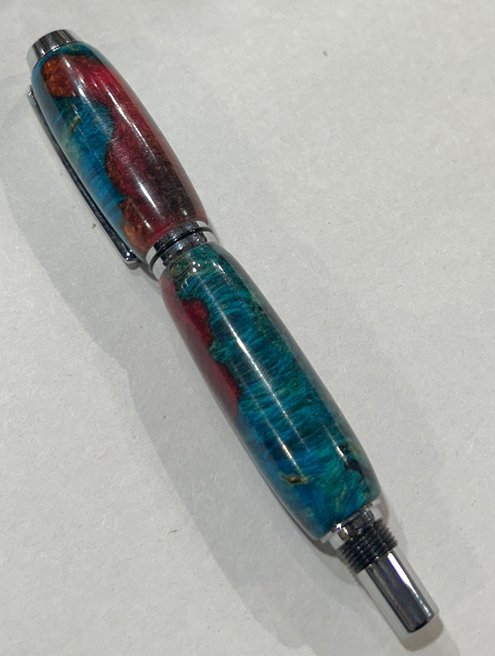 Roller ball pen with silver metal and black hardware with. And blue burl wood with pink little bit of brown acrylic a. CA finish.