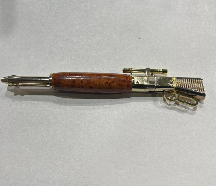 Ball point,  lever, action, rifle,pen with a gold pleaded metal design, hardware . And an Bueno wood . CA finish.