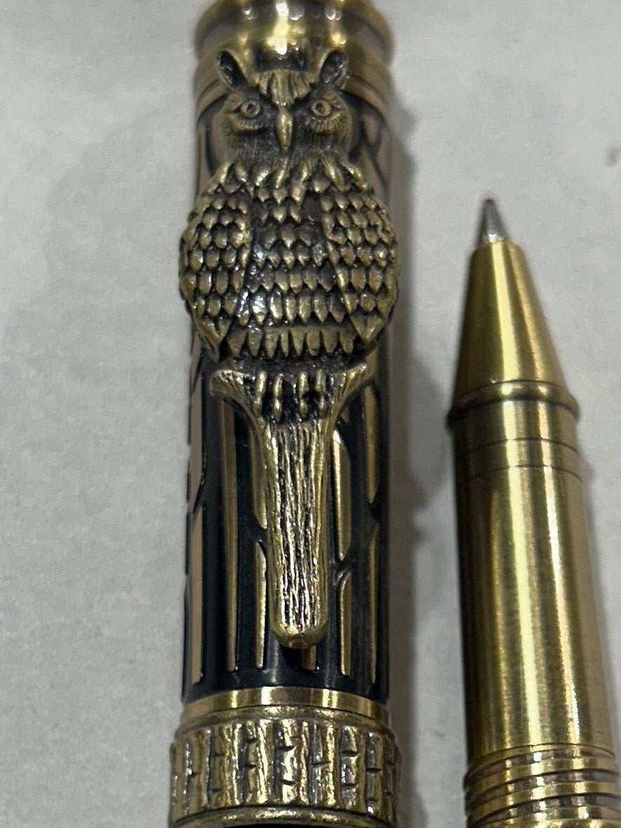 Roller ball pen with a bronze metal I will design owl. And a in black pine wood . friction finish.