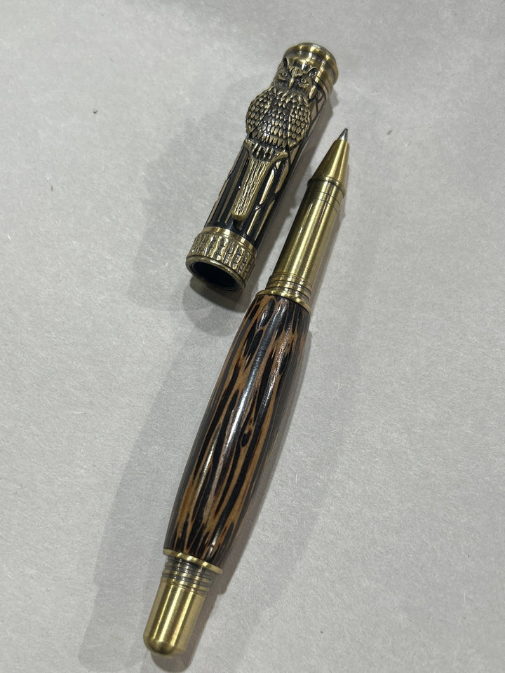 Roller ball pen with a bronze metal I will design owl. And a in black pine wood . friction finish.