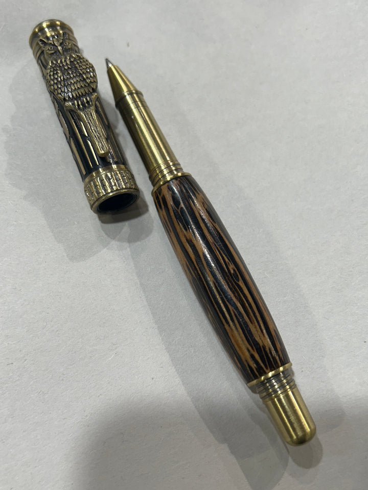Roller ball pen with a bronze metal I will design owl. And a in black pine wood . friction finish.