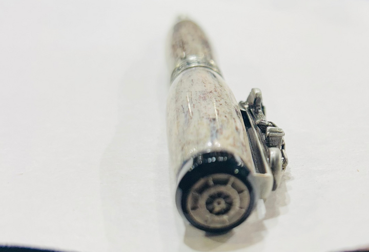 Roller ball pen with a brush nickel, metal and black hardware with ocean themed. And deer antler. CA finish.