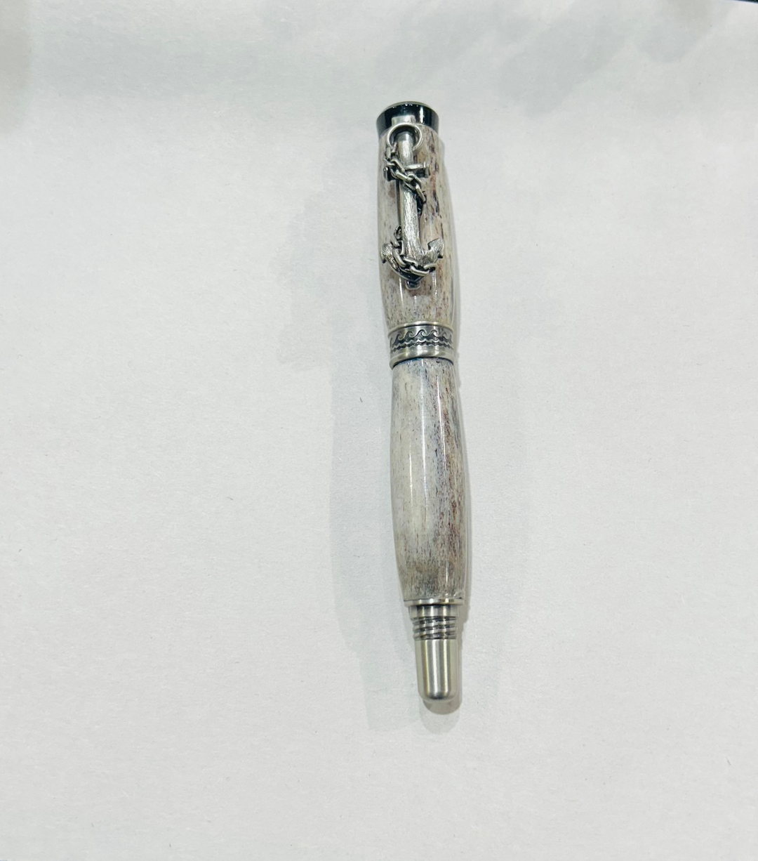 Roller ball pen with a brush nickel, metal and black hardware with ocean themed. And deer antler. CA finish.