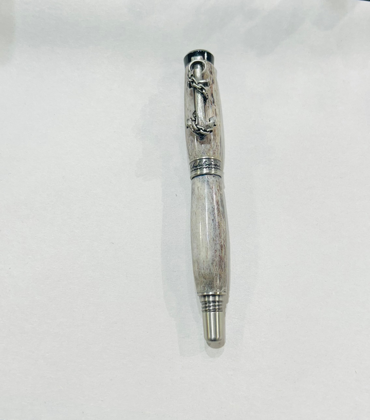 Roller ball pen with a brush nickel, metal and black hardware with ocean themed. And deer antler. CA finish.