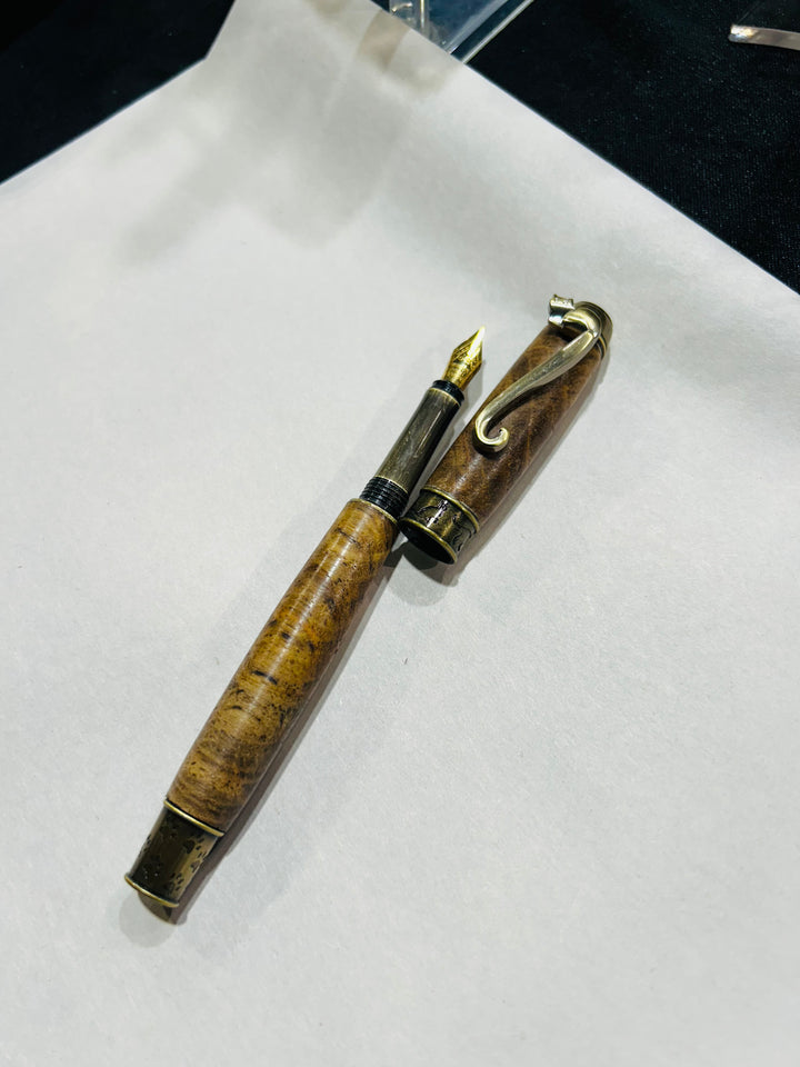 Copy) medium point nib fountain pen with a bronze metal cat design, hardware . And a in pecan wood . friction finish.