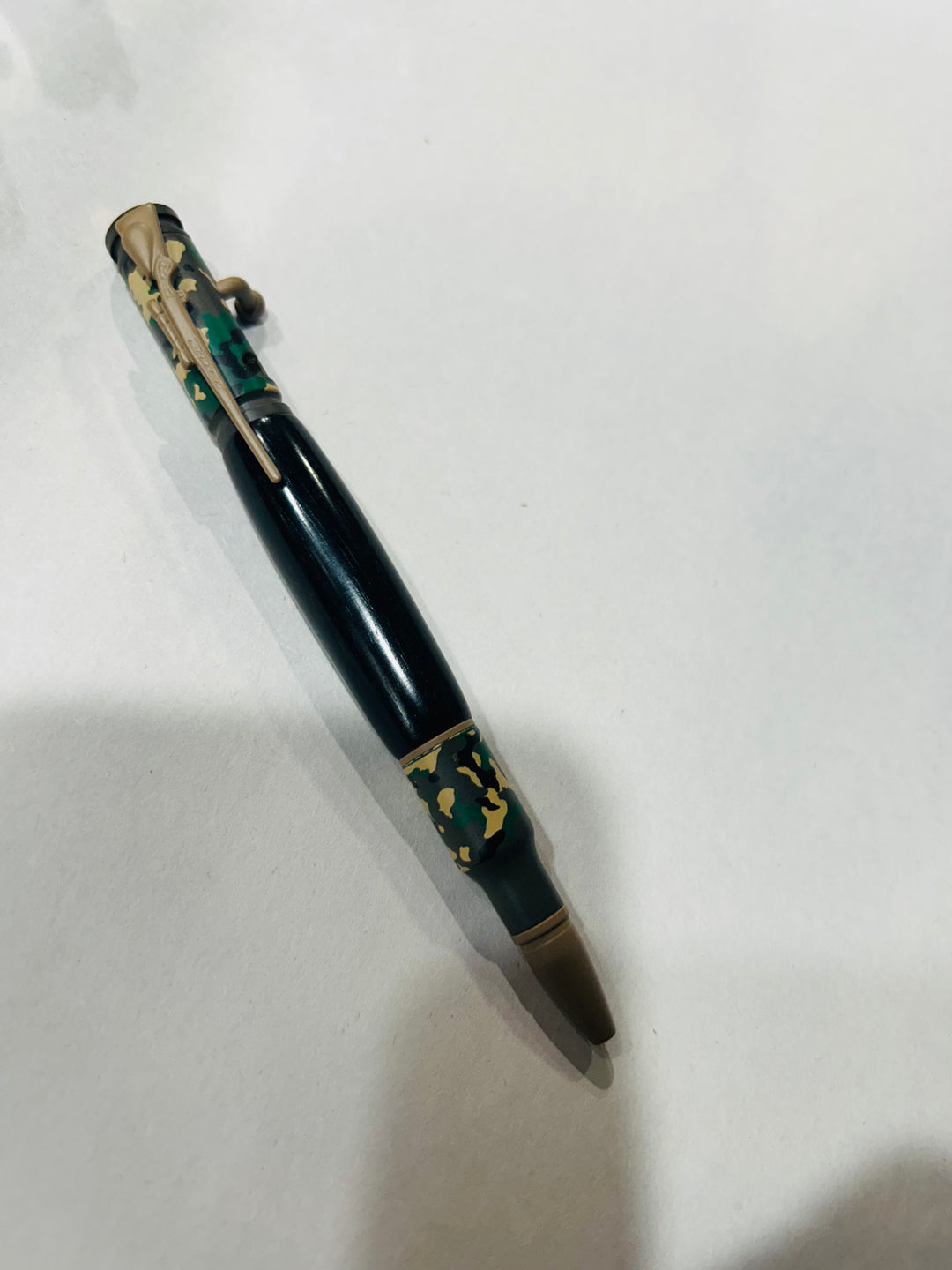 Ball point rifle pen with and camouflage painting  hardware . And with Blake Ebony wood. Friction finish.