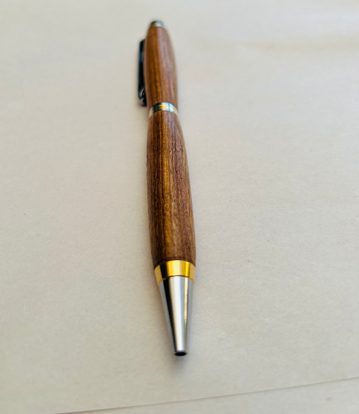 Ball point pen with silver and gold metal  hardware and stylus. And pecan wood . Friction polish.