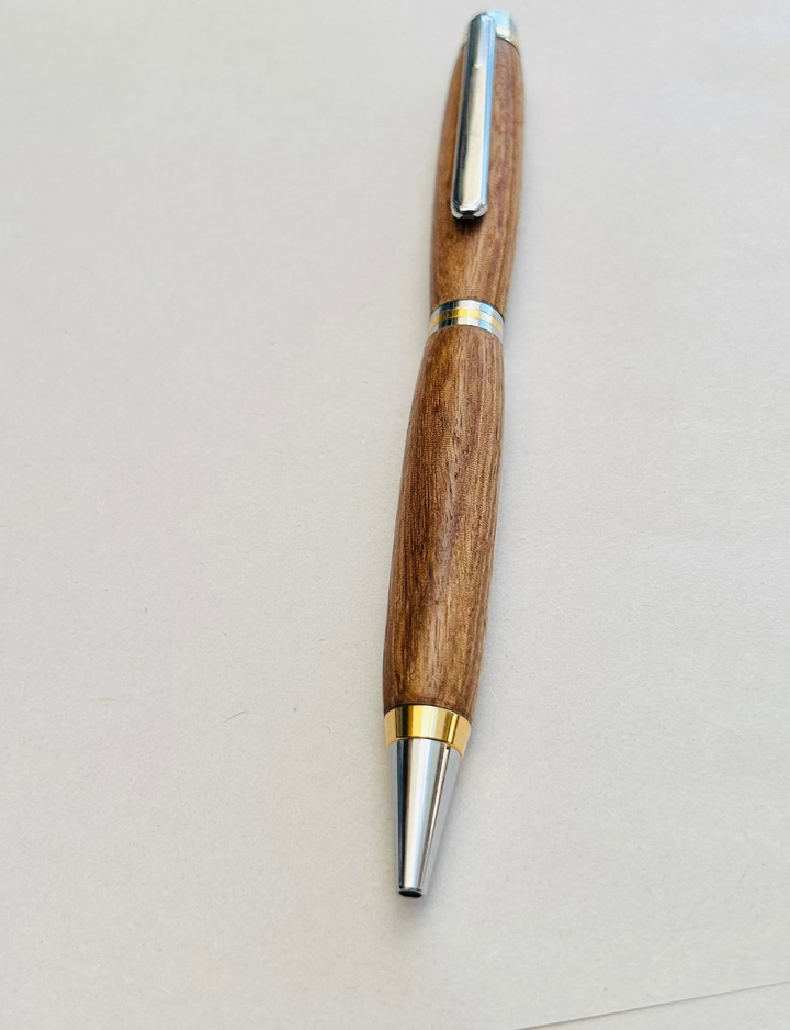 Ball point pen with silver and gold metal  hardware and stylus. And pecan wood . Friction polish.