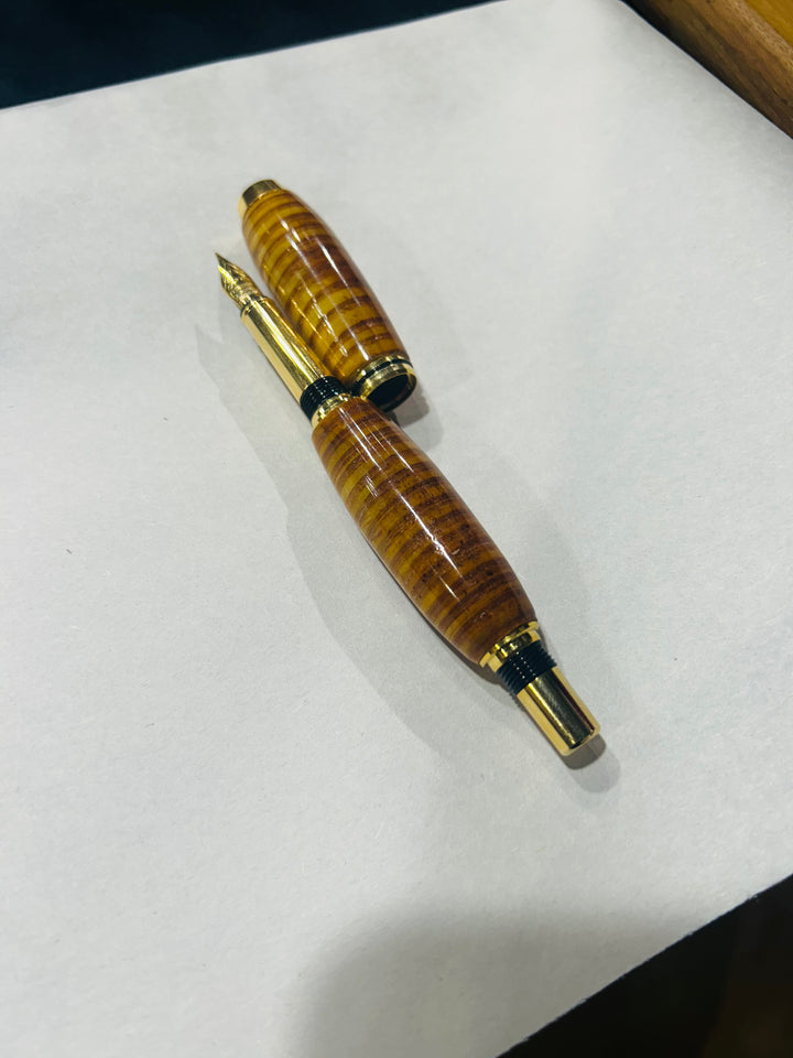 (Copy) (Copy) Fine point nib fountain pen with a gold metal hardware . And a in cheese wood burl strip design.and a CA finish.
