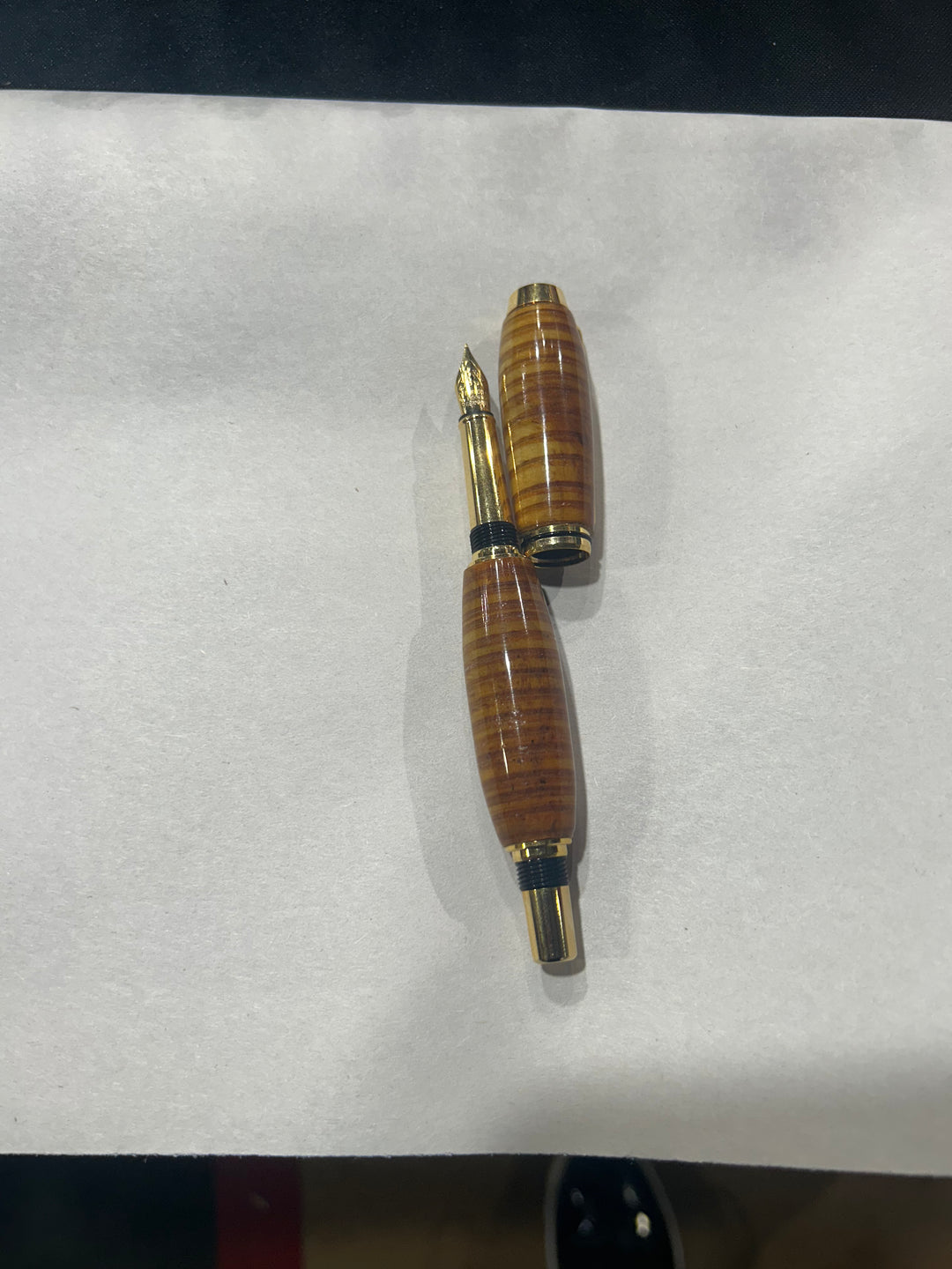(Copy) (Copy) Fine point nib fountain pen with a gold metal hardware . And a in cheese wood burl strip design.and a CA finish.
