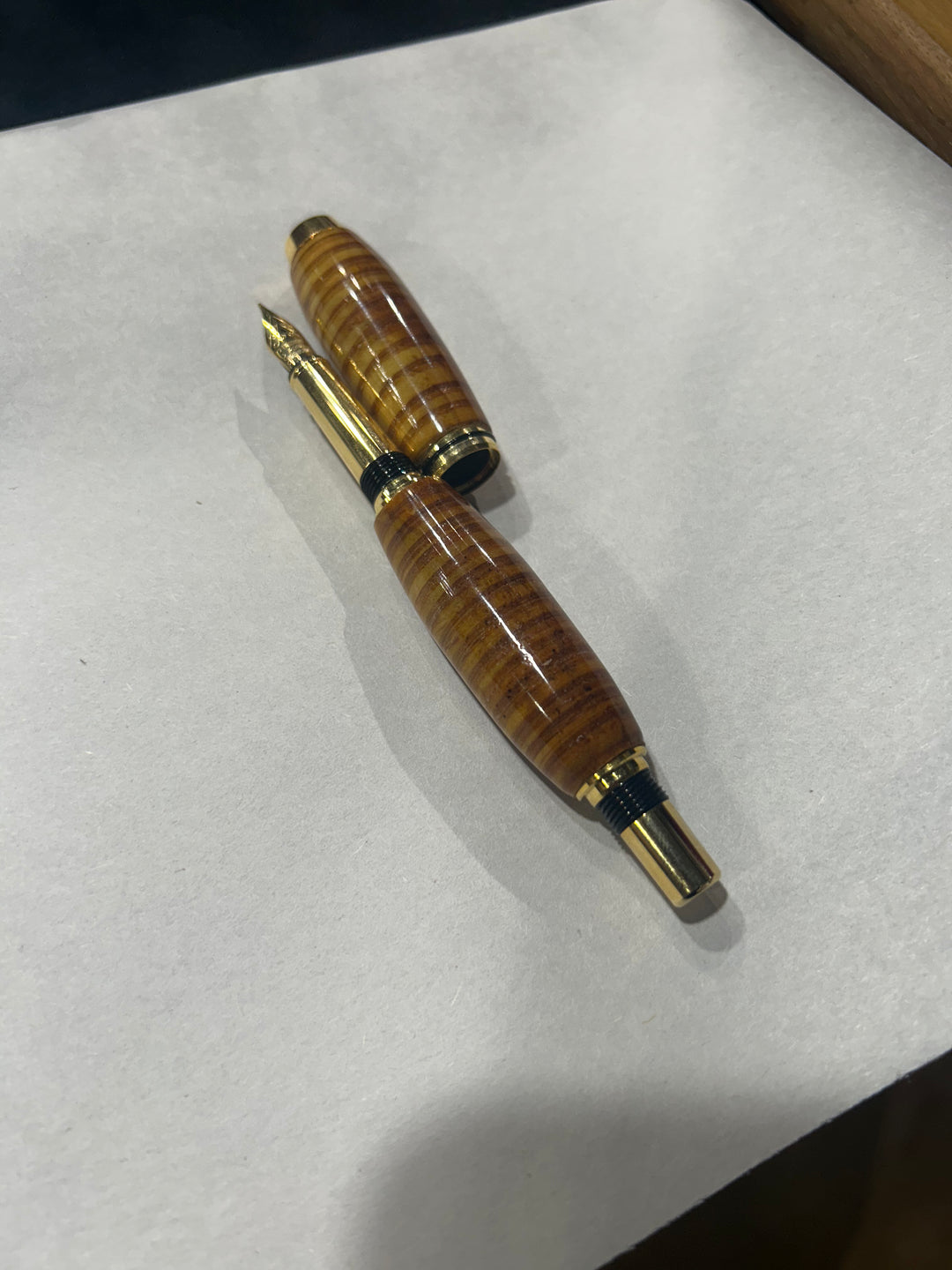 (Copy) (Copy) Fine point nib fountain pen with a gold metal hardware . And a in cheese wood burl strip design.and a CA finish.