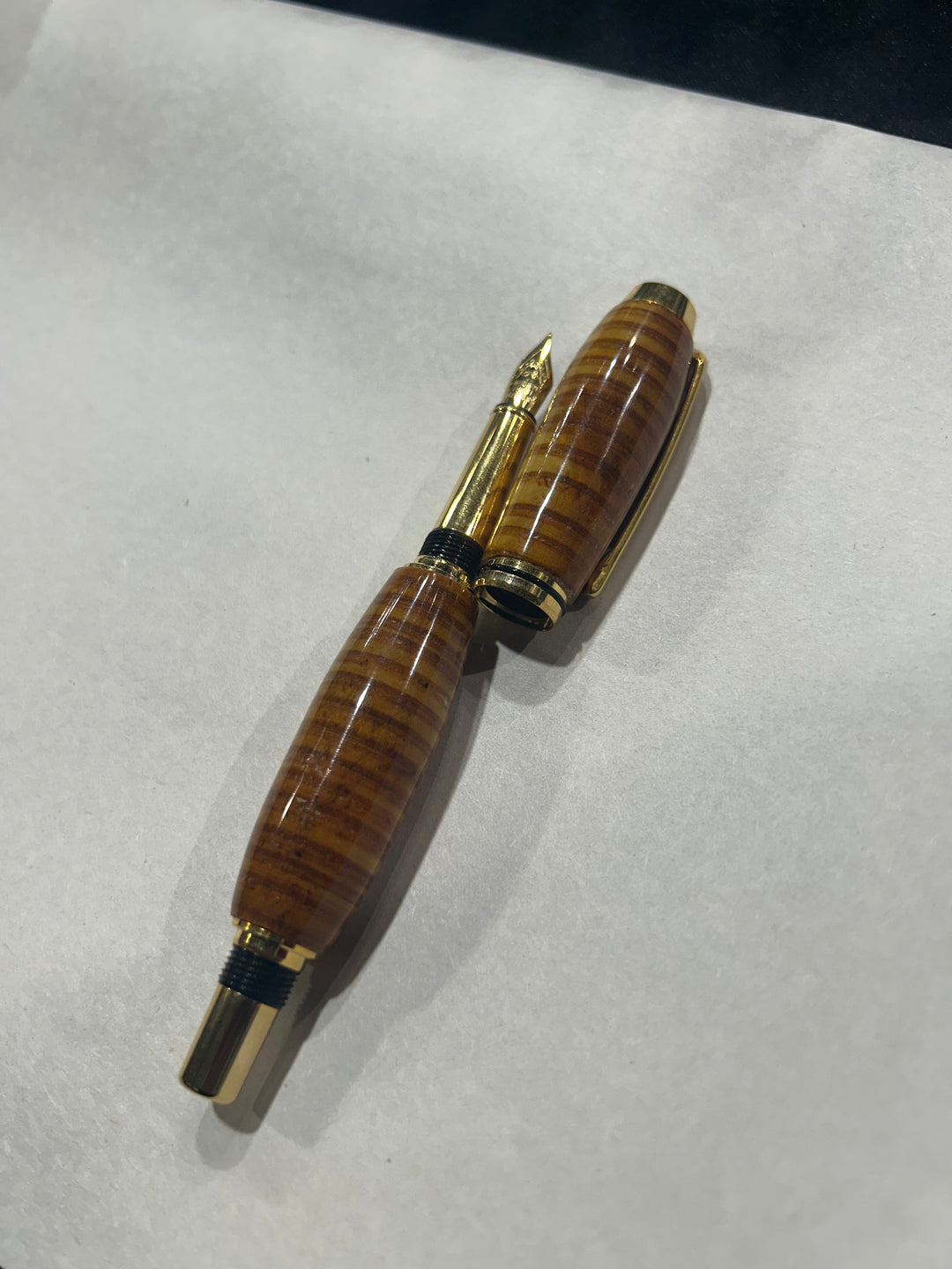 (Copy) (Copy) Fine point nib fountain pen with a gold metal hardware . And a in cheese wood burl strip design.and a CA finish.