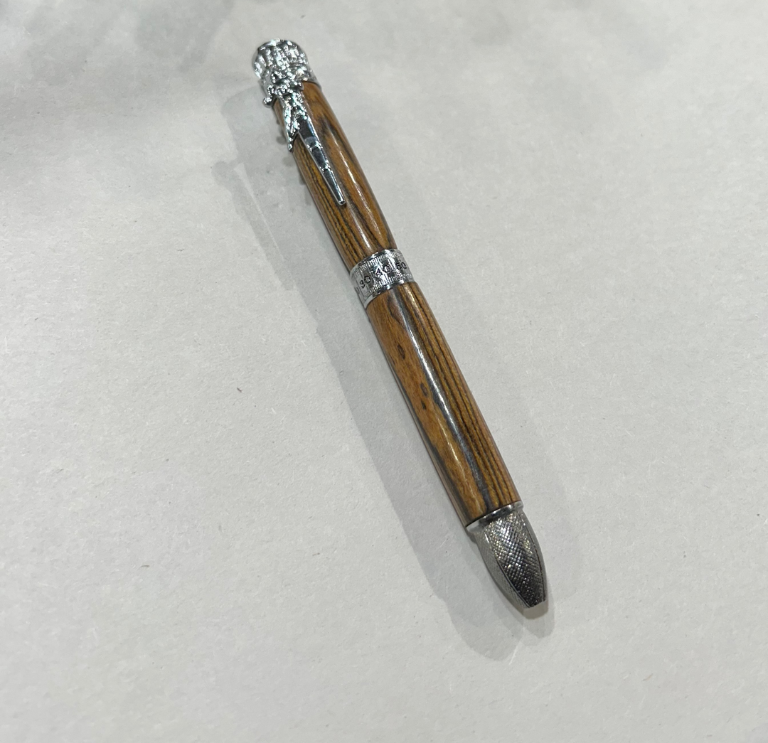 Ball point pen with a silver metal  hardware. And football thing. Bcody Wood .and friction finish.