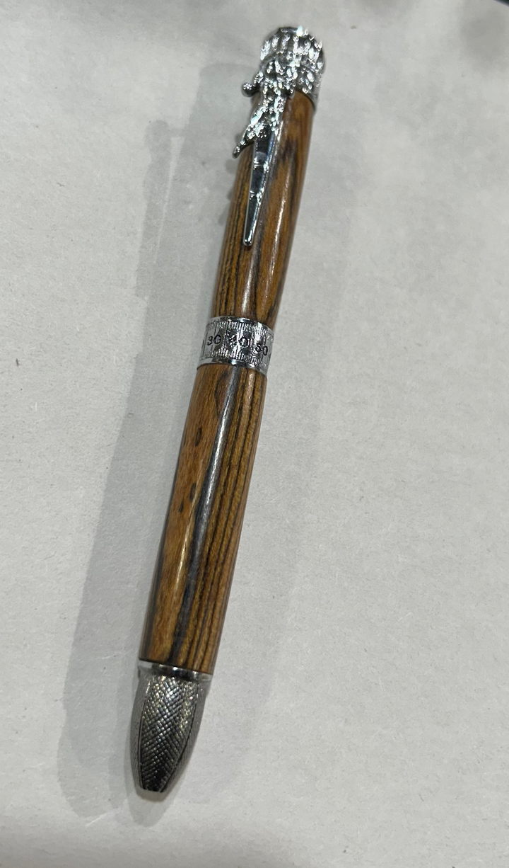 Ball point pen with a silver metal  hardware. And football thing. Bcody Wood .and friction finish.