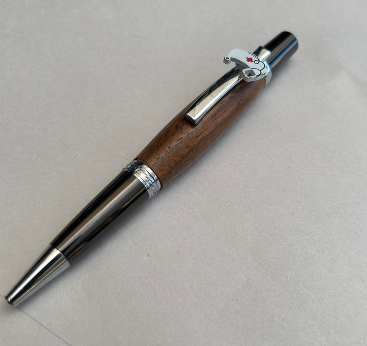 Ball point pen with silver and gun metal  hardware  with the nurse themed peace on it and stylus. And walnut wood. Friction polish.