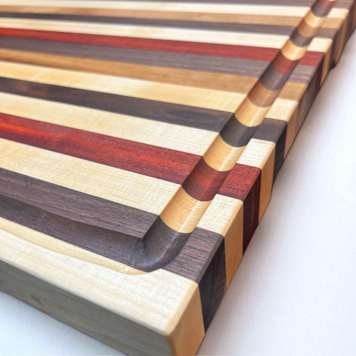 Edge Grain Walnut, Padauk, Maple, and Cherry Cutting Board